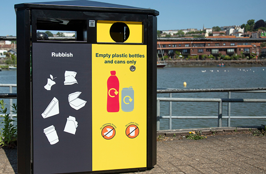 A yellow and black in the loop bin that collects both rubbish and recycling materials like glass, cans and plastic