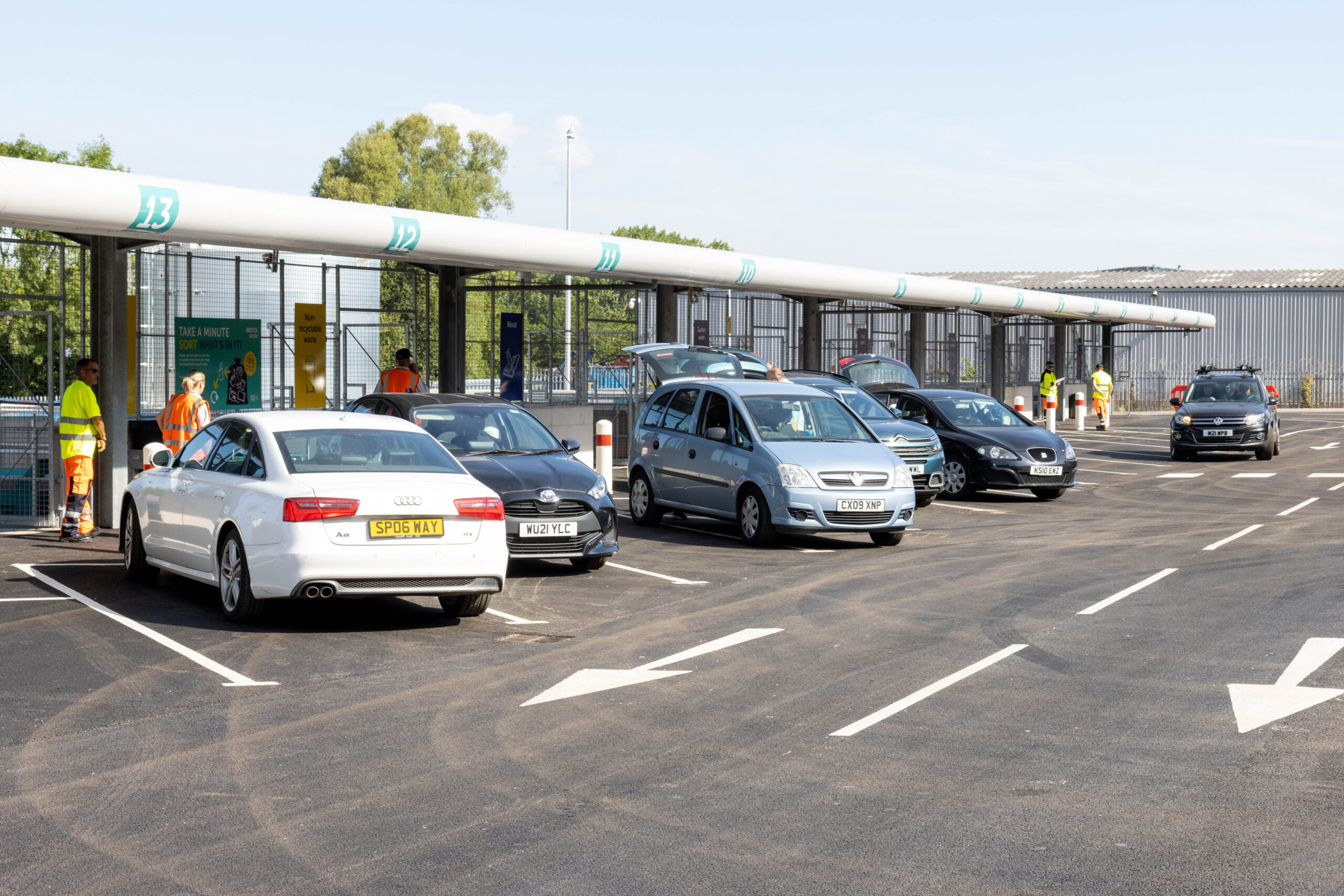 Cars line up to next to the bays to recycle household items at the recycling centre