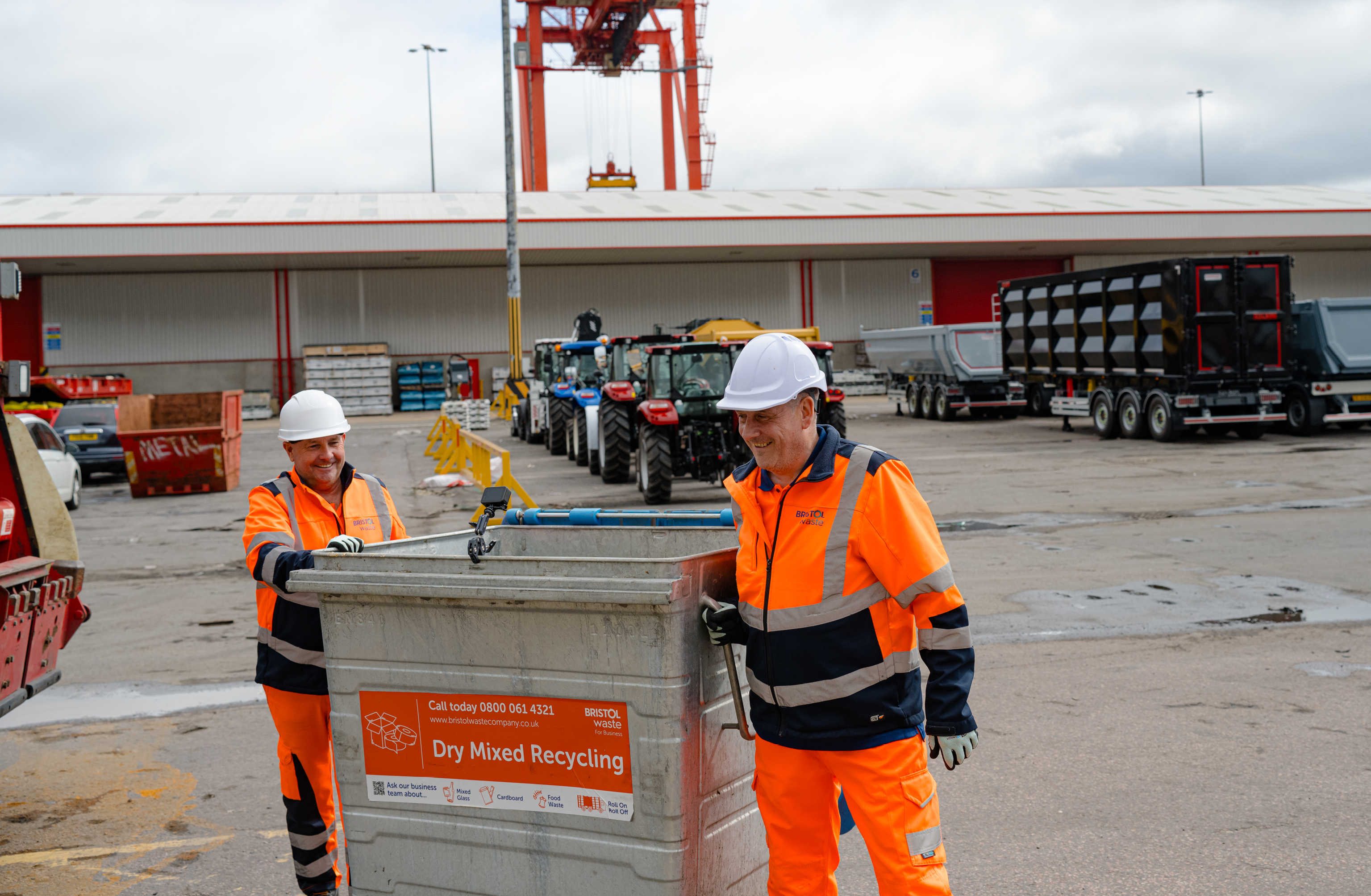 Two Bristol Waste team members with a large recycling bin