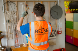 A volunteer at the Reuse Shop is replenishing stock