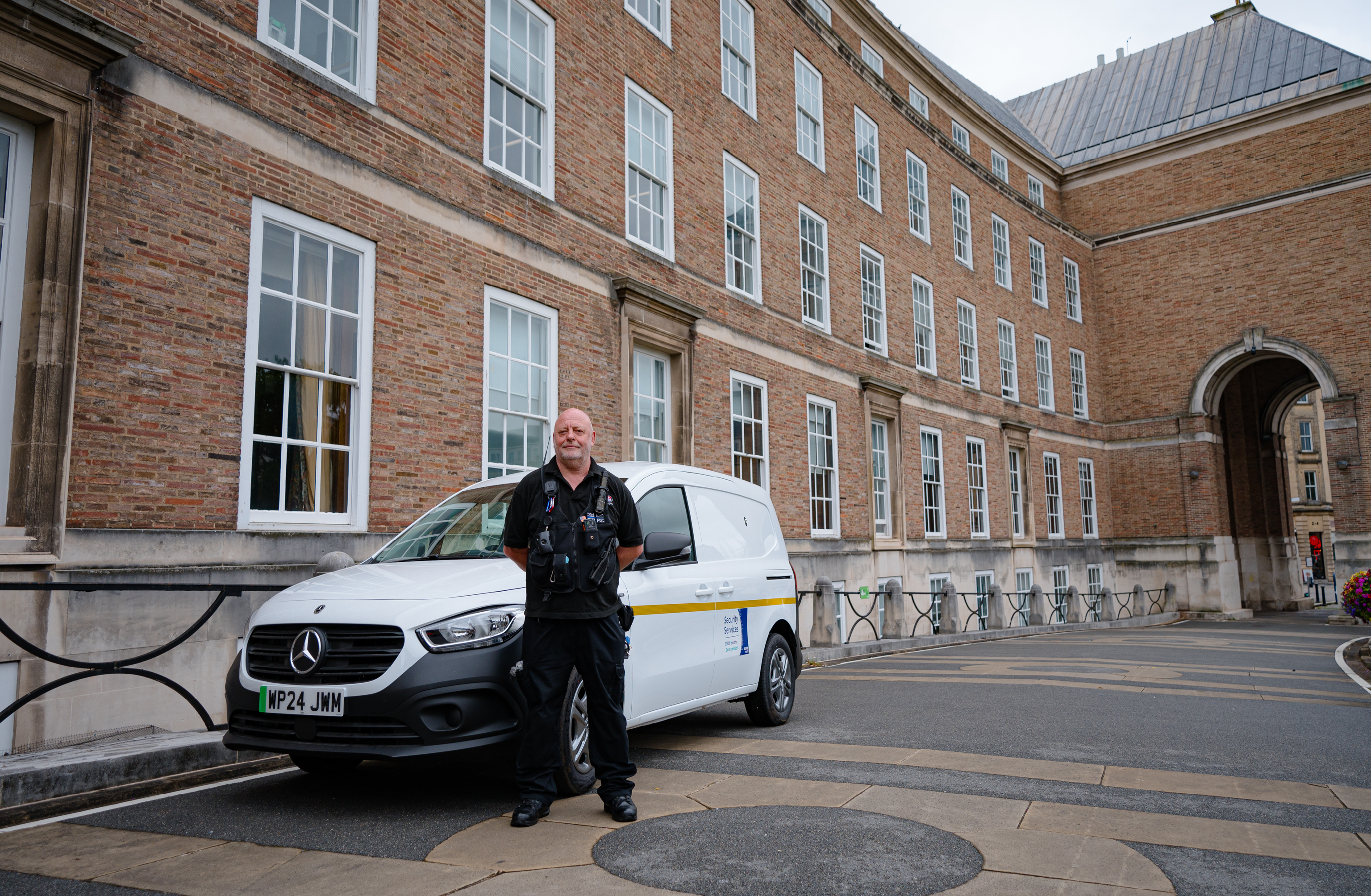 A security team member standing outside city hall in Bristol.