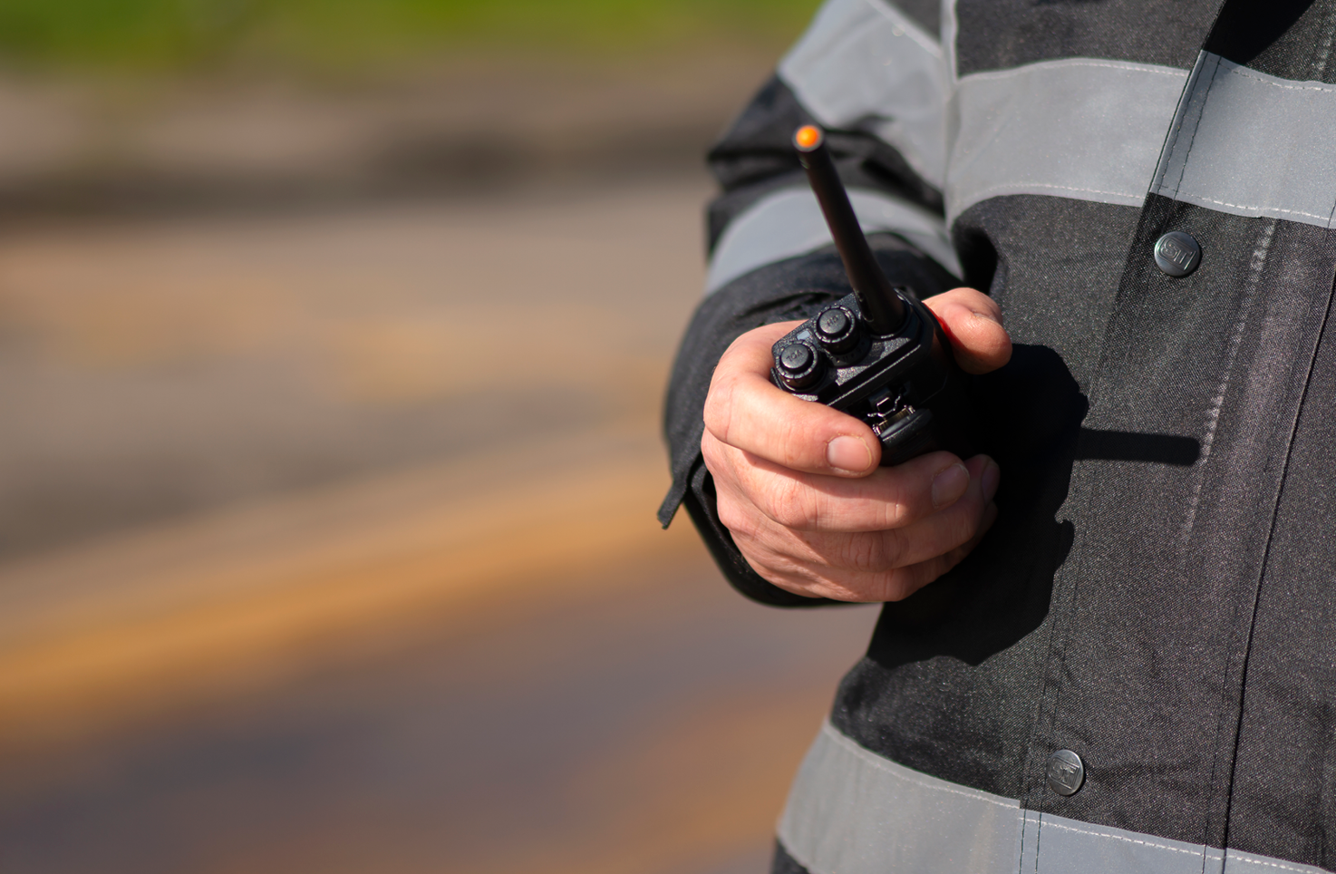 A security team member holding a walky-talky.