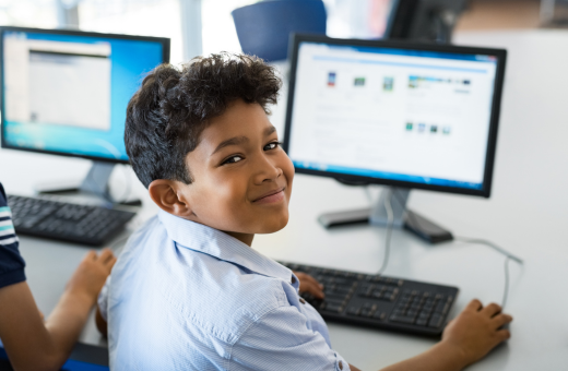 Boy with computer at school