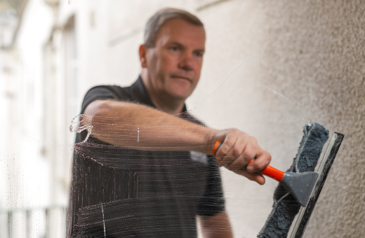 Man cleaning window from outside