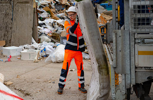 A Bristol Waste employee discarding of fly-tip at Avonmouth transfer station