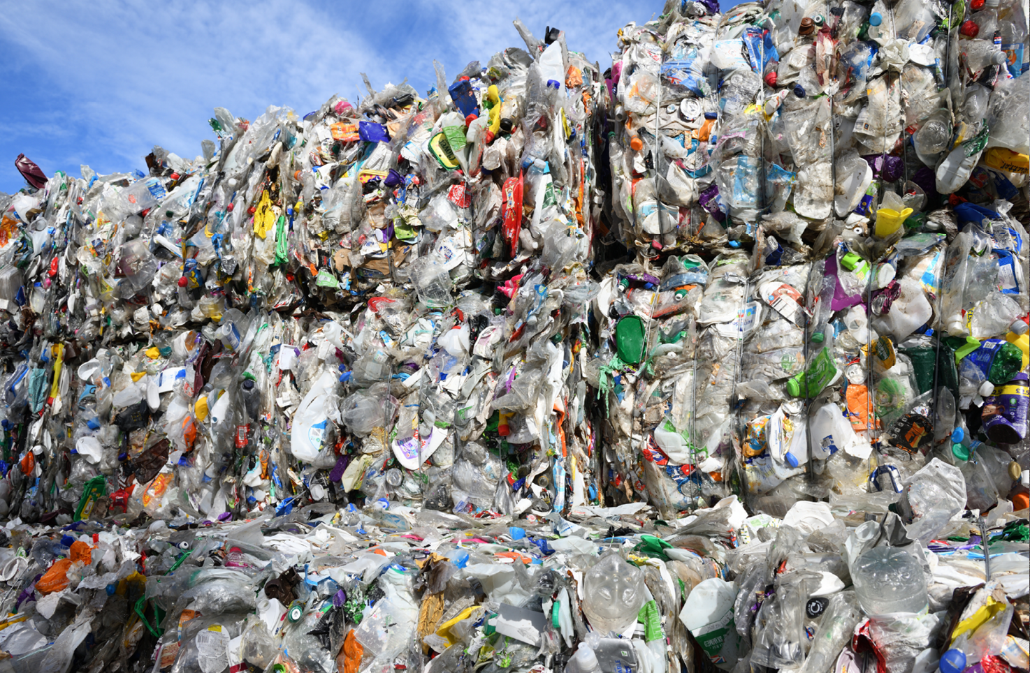 Bales of plastic recycling stacked up in piles