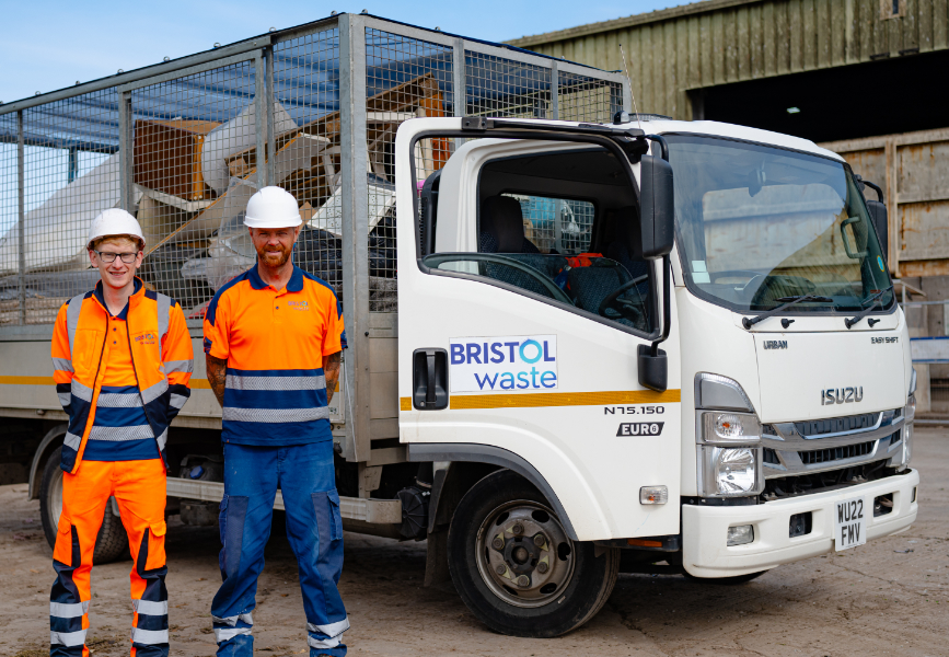 Two men in high-visibility clothing standing next to a Bristol waste caged vehicle