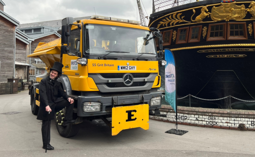 A Brunel actor stands in front of a gritter and the SS Great Britain