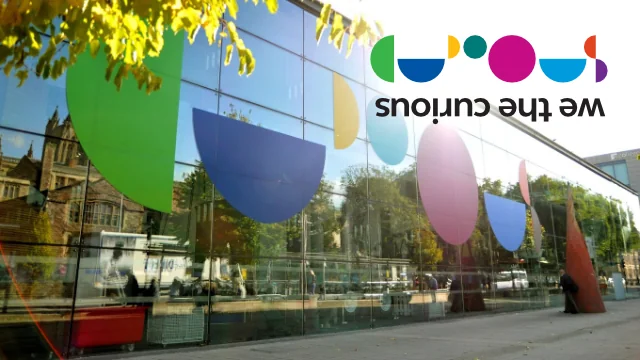 Outside of building with coloured semi circles and We The Curious Logo