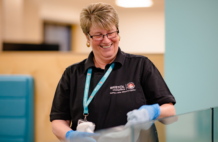 Woman wiping a perspex screen