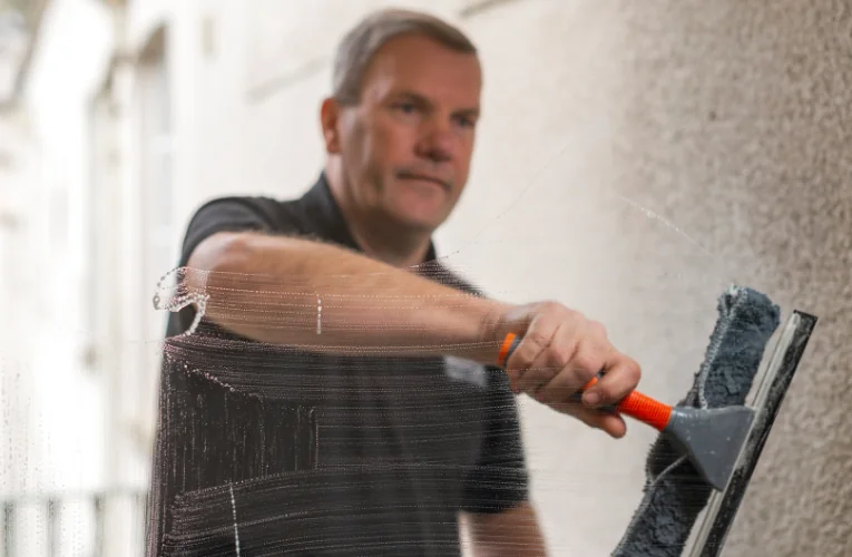 Man cleaning window
