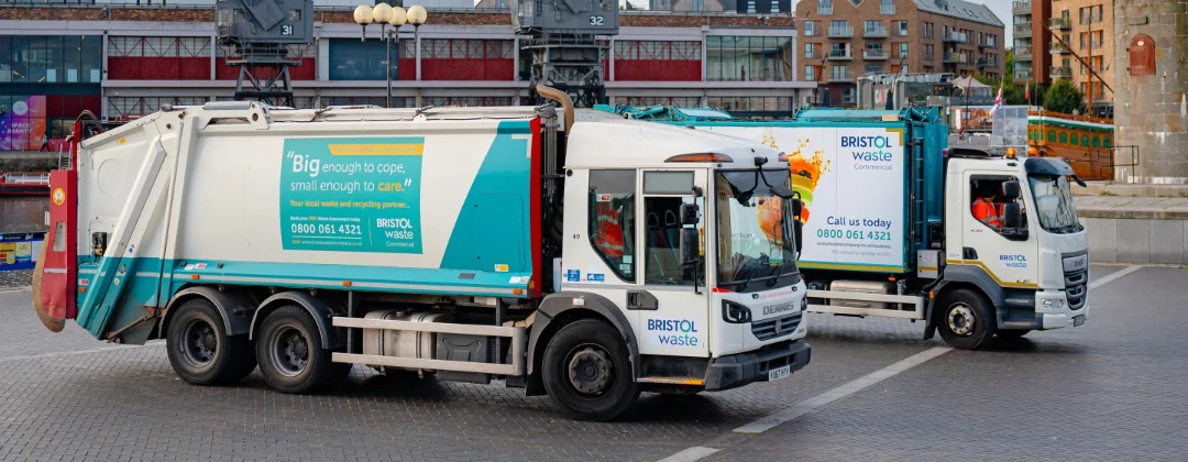 Two recycling trucks with a Bristol Waste logo