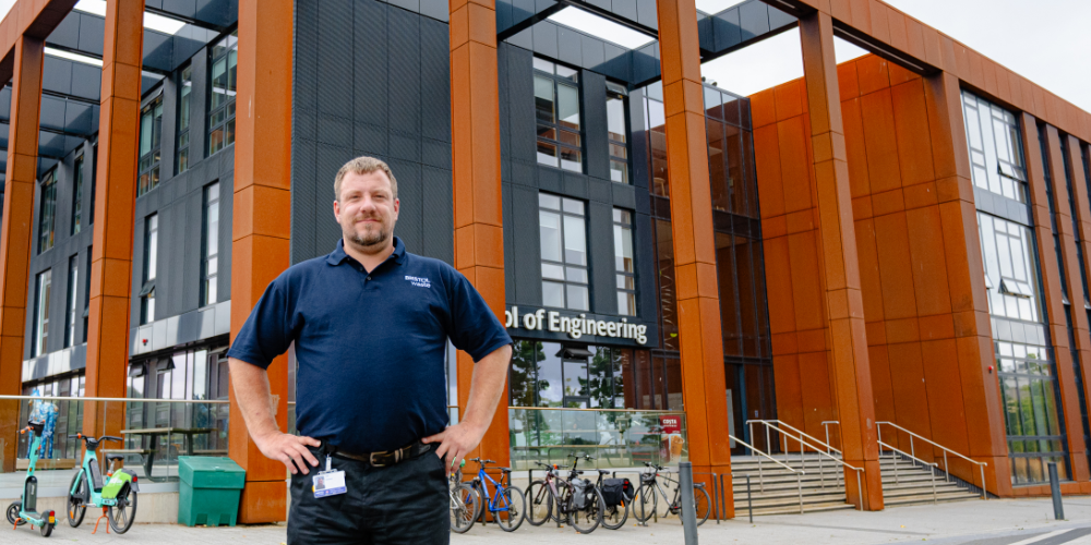 Blog: FM mistakes that increase your carbon footprint - Image shows man with Bristol Waste top, standing in front of a building