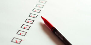 boxes with red ticks and a red pen on a page