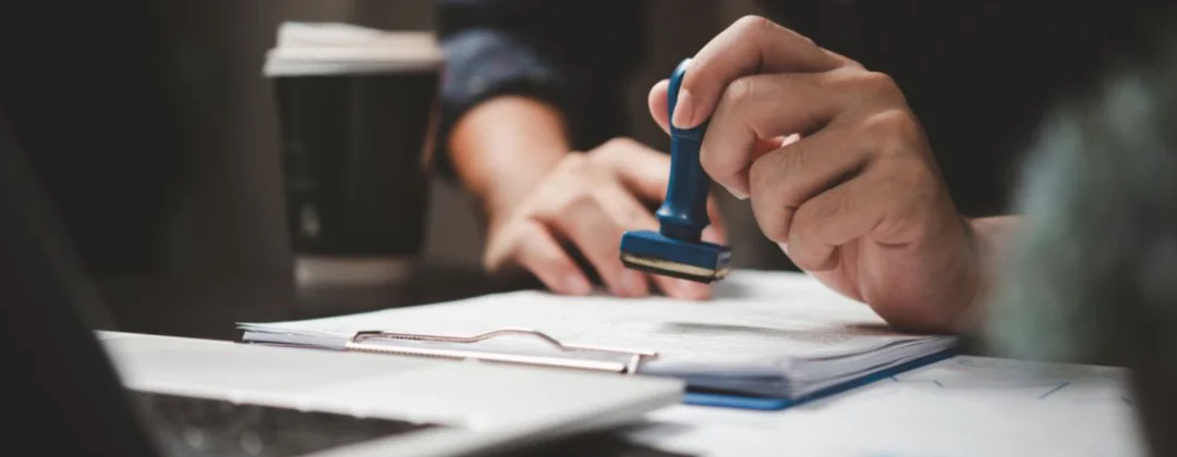 person stamping a certificate