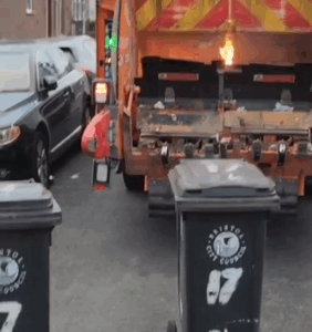 A bin lorry with flames coming out of the back, the fire was caused by incorrectly recycled batteries Bristol