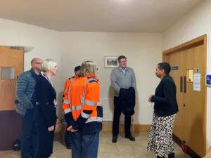 A group of people being shown round St Peter's Hospice