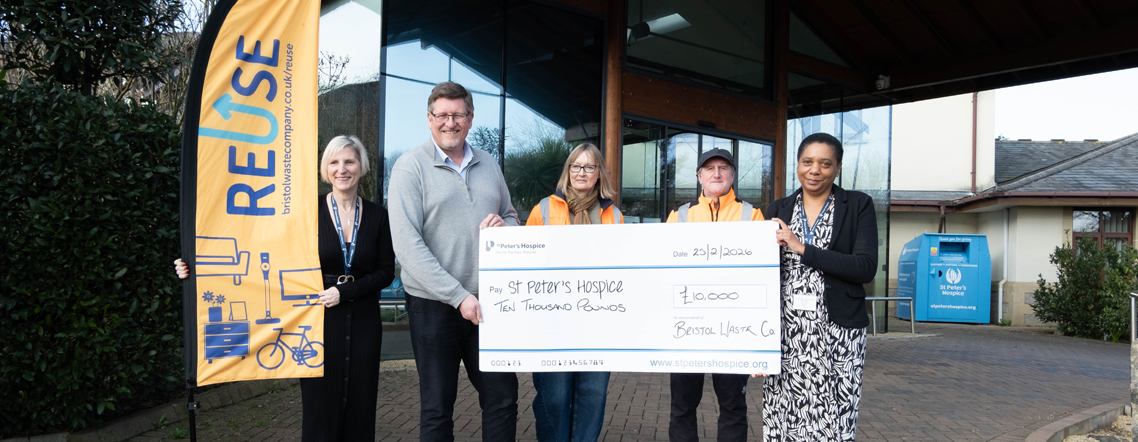 5 people are handing over a big cheque